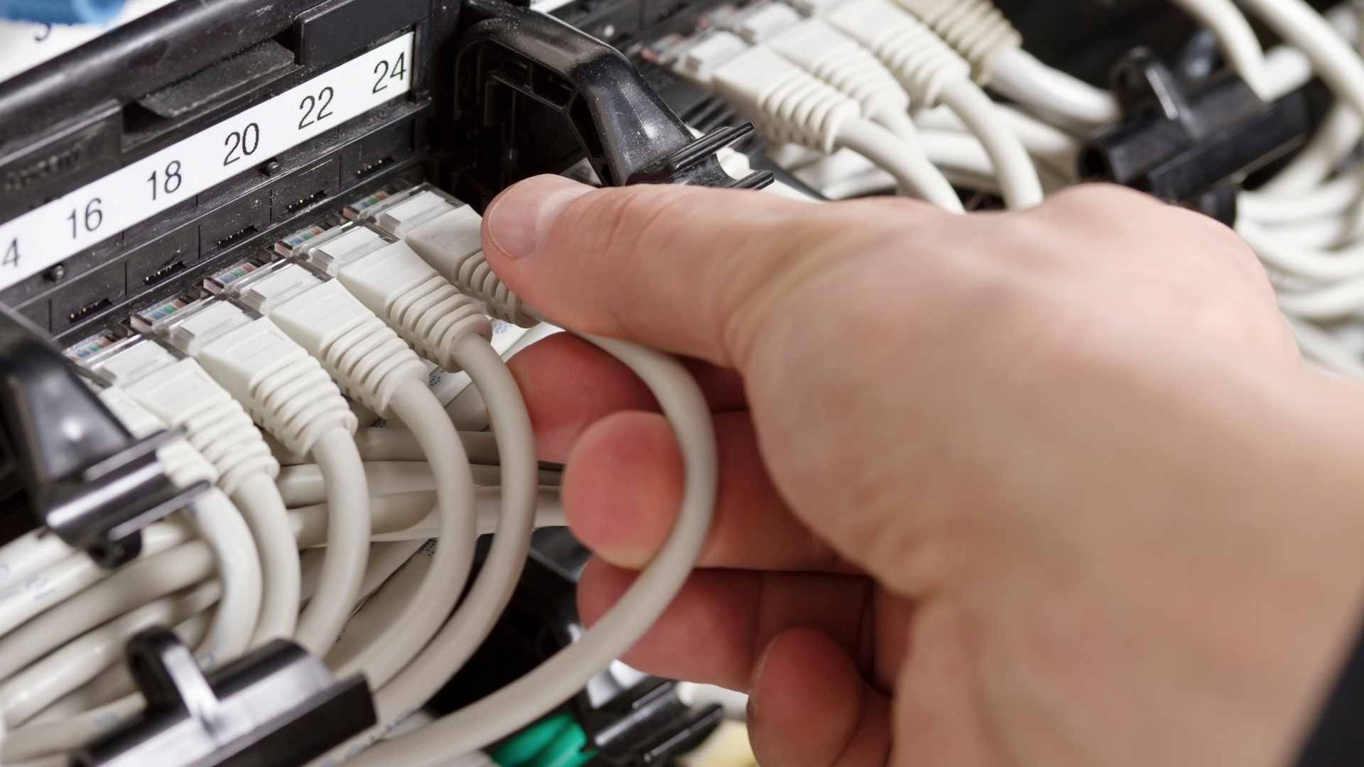 Technician using augmented reality to view digital twin for accurate cable installation.